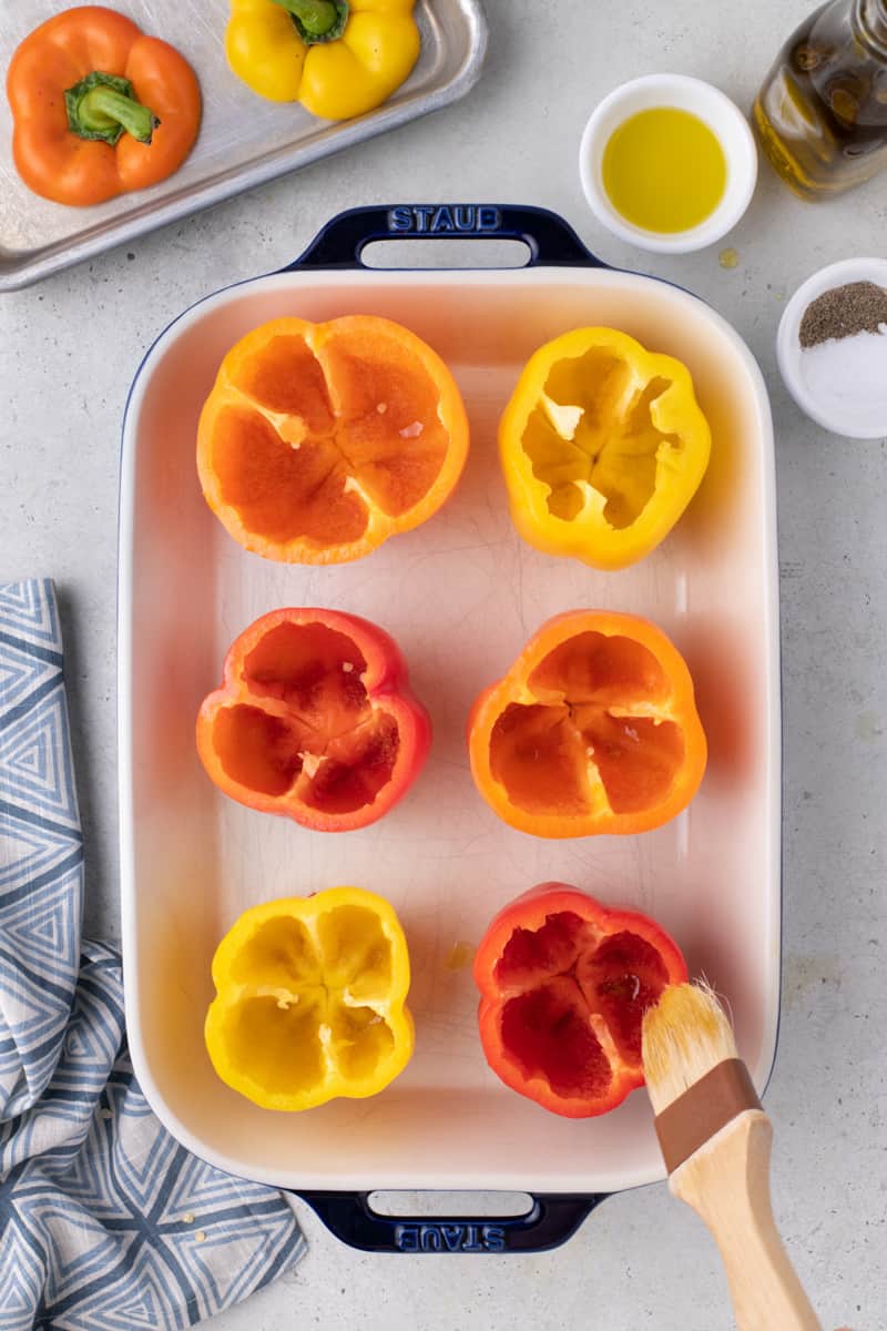 cut off the tops of the bell peppers and season the insides