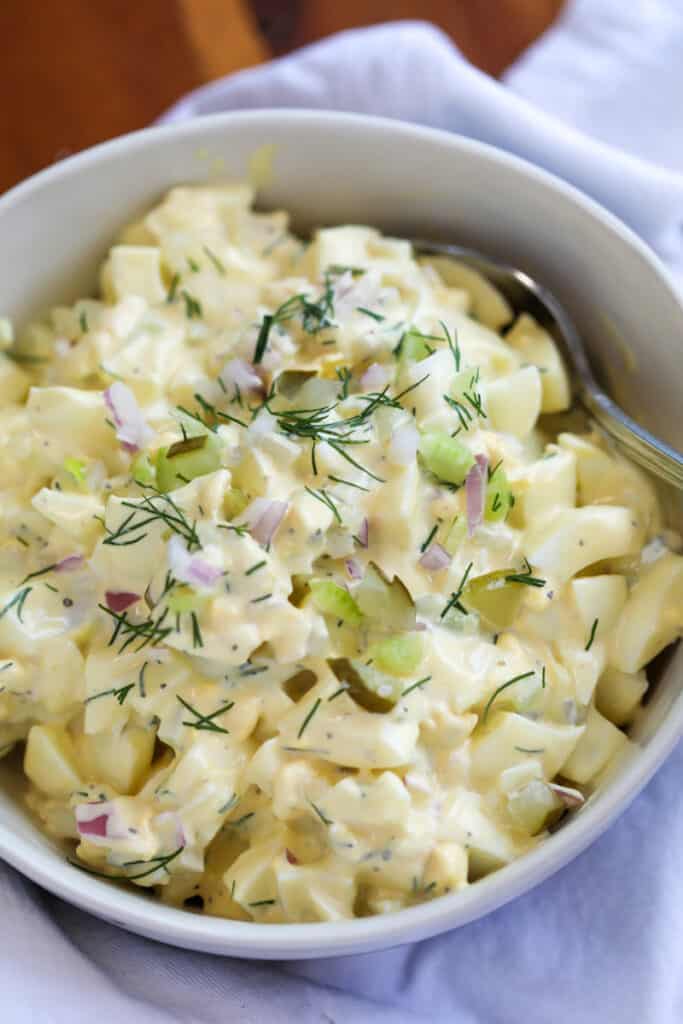 dill pickle egg salad in a white bowl