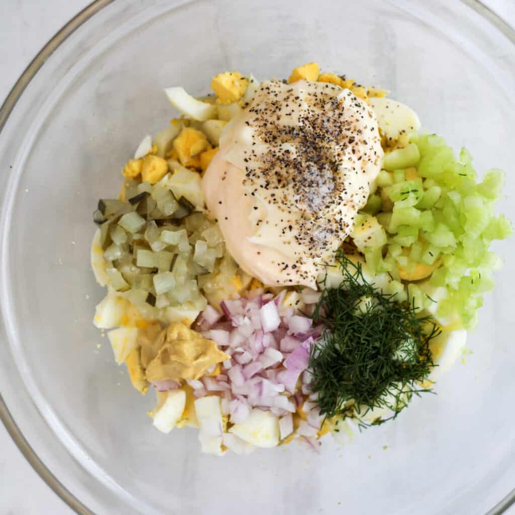 egg salad with pickle ingredients in a bowl