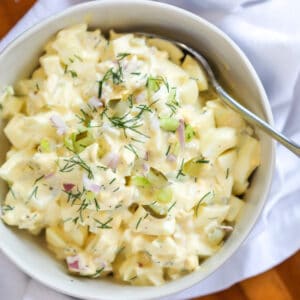egg salad with pickles on a spoon