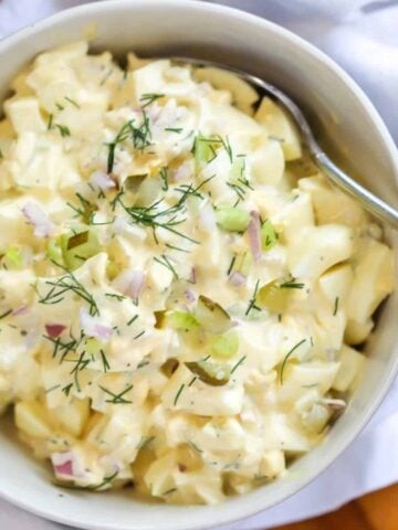 egg salad with pickles on a spoon