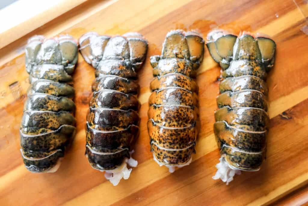 make a fancy steak and lobster dinner starts with prepping on a cutting board