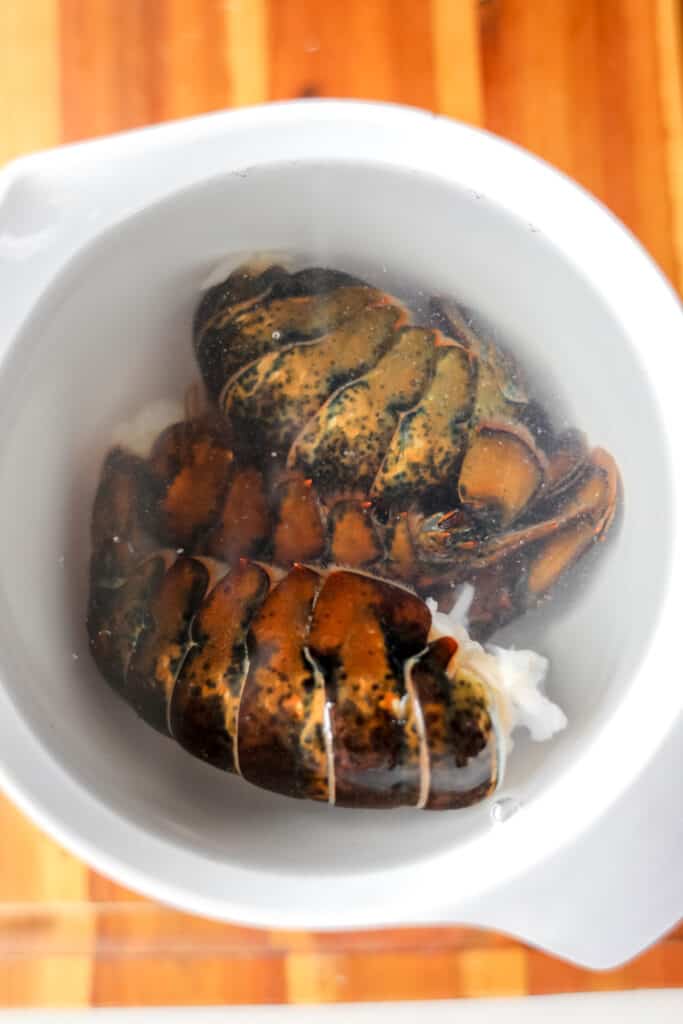 how to butterfly lobster tail 3 soaked in water in bowl