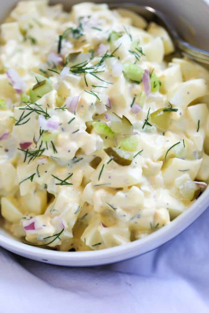 low carb egg salad close up garnished with dill and red onions