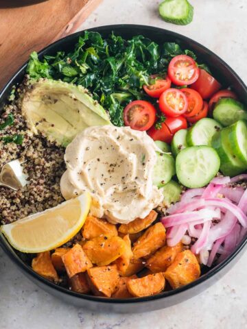 mediterranean bowl recipe close up with a fork in quinoa