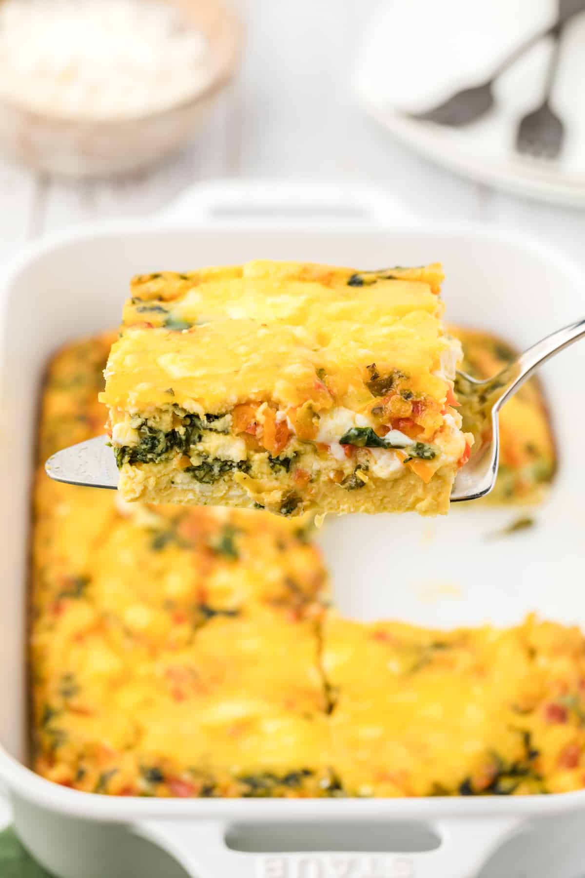 A slice of breakfast casserole on a spatula.