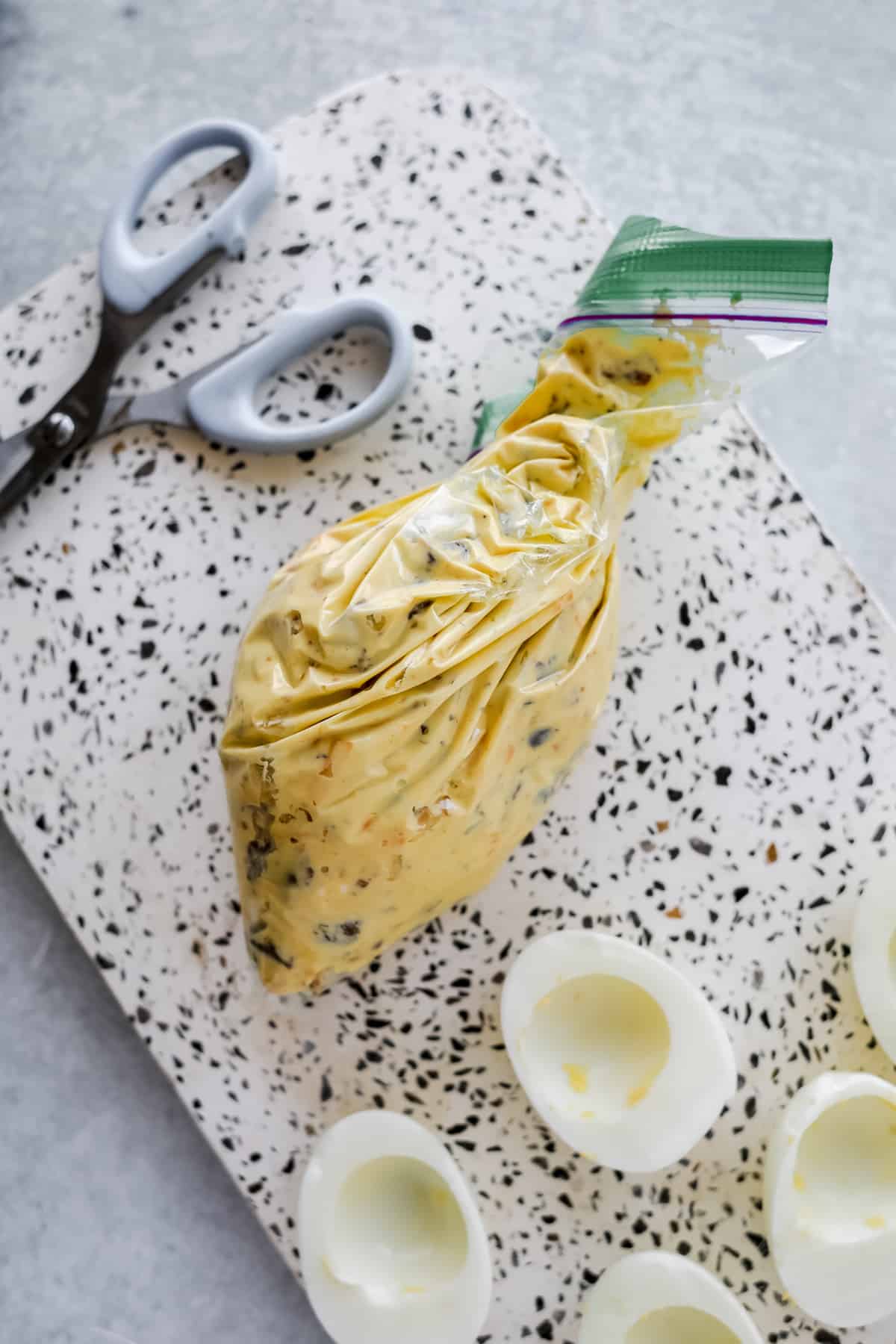 Filling a sandwich baggie with deviled egg filling, ready to be piped.