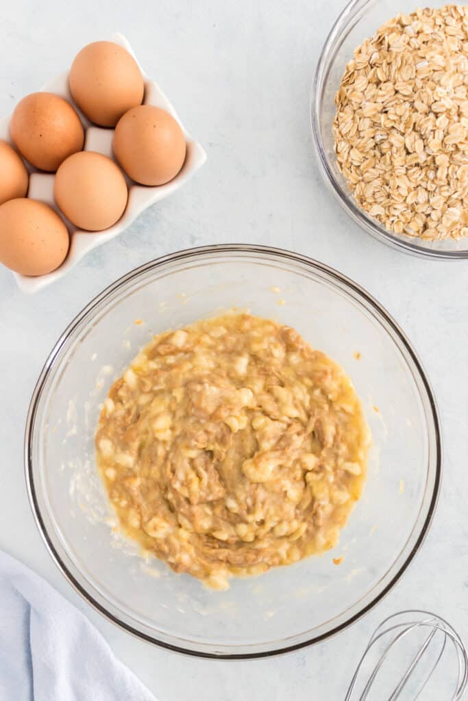 Mashed bananas in a small mixing bowl.