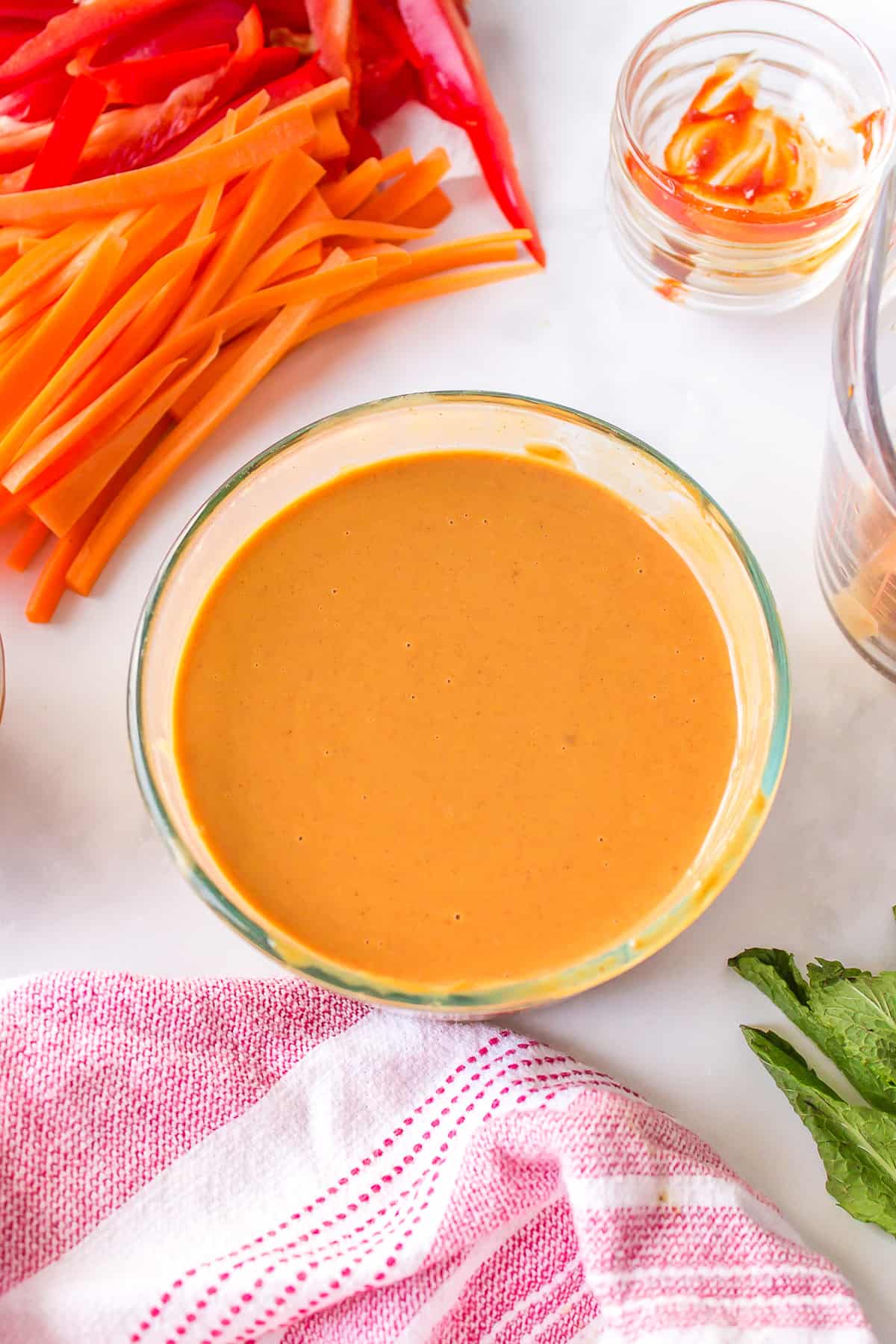 A bowl of spring roll peanut dipping sauce that has been mixed together.
