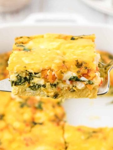 A slice of breakfast casserole on a spatula.