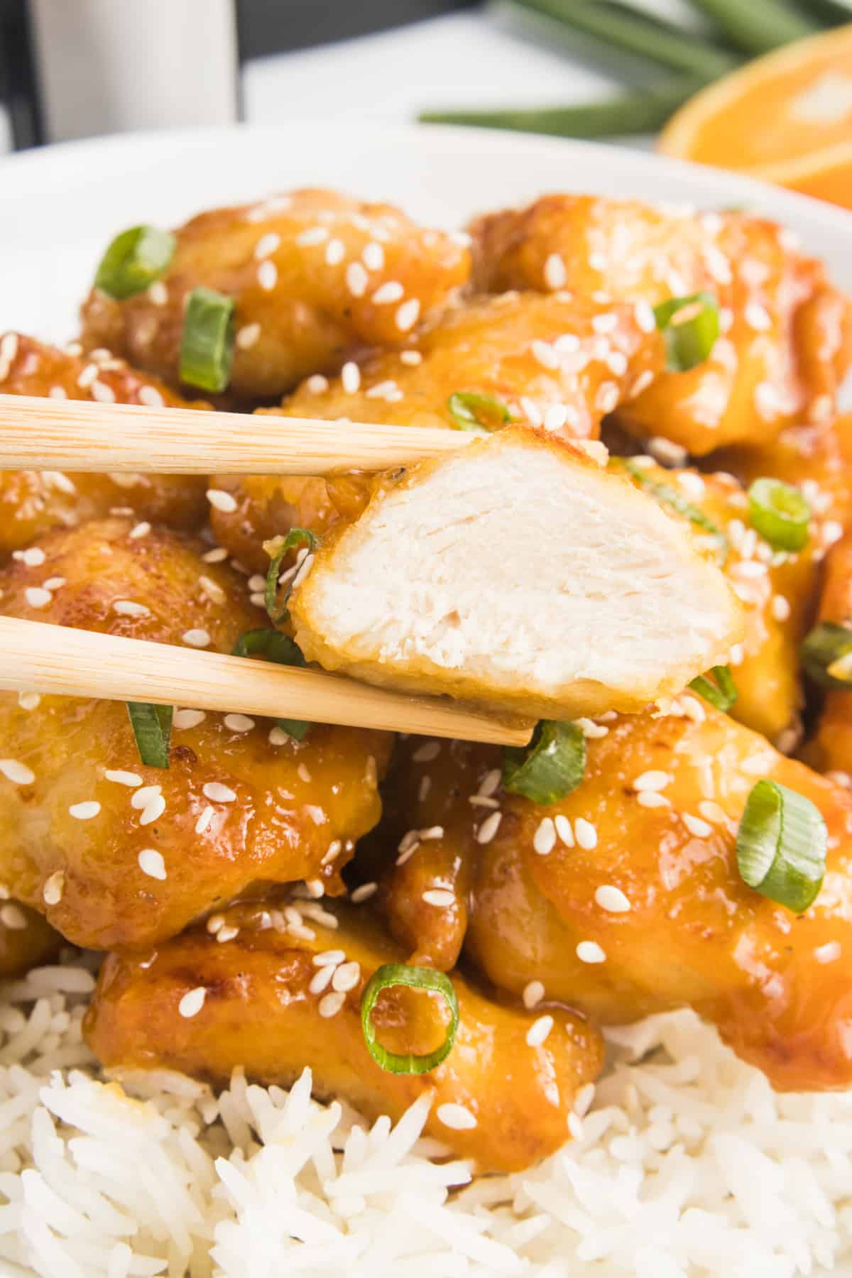 Close up of orange chicken bite.