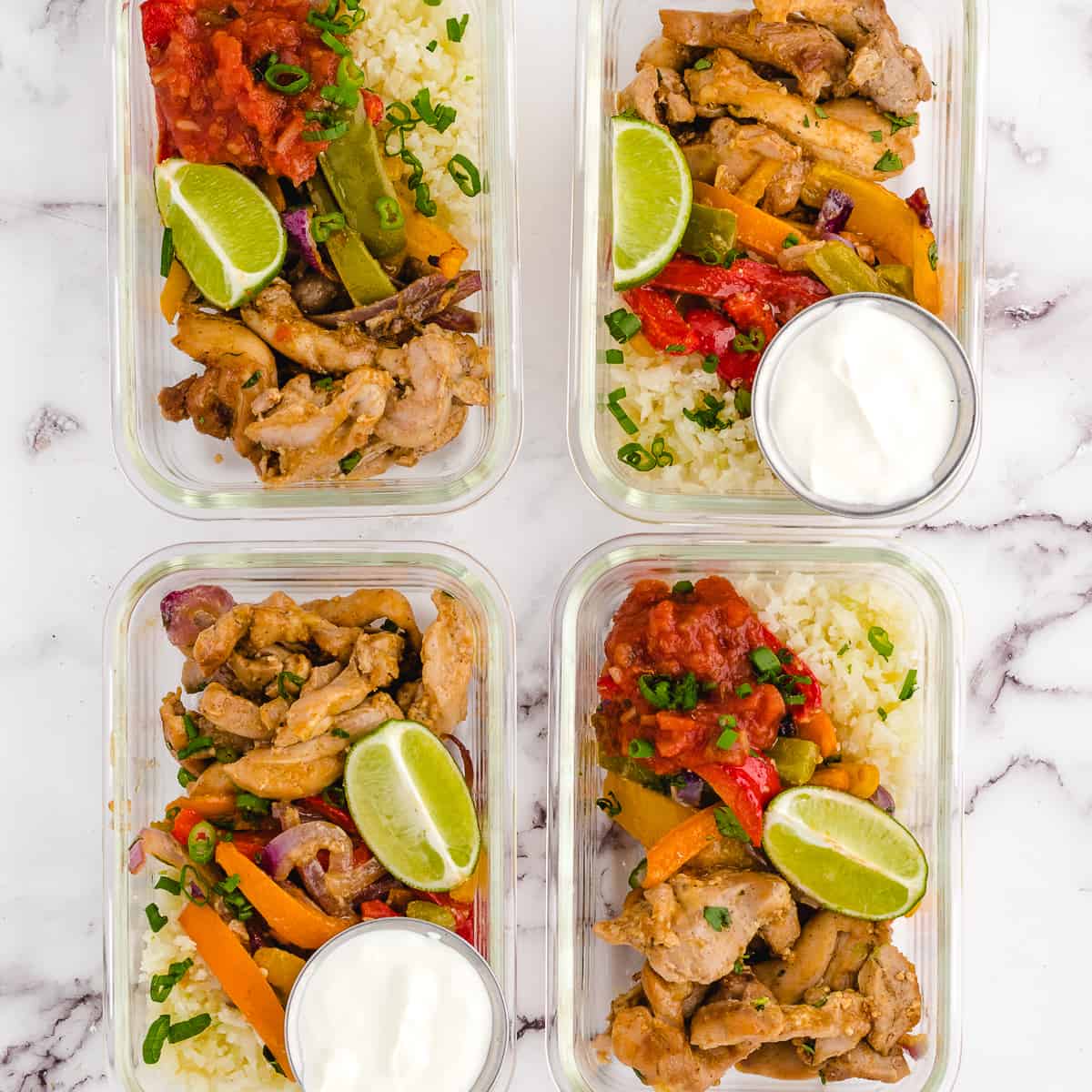 4 meal prep containers with chicken fajitas in them.