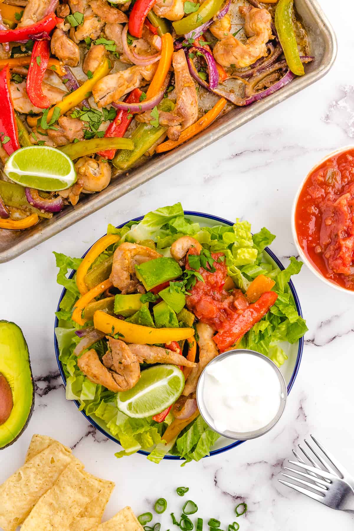 Served sheet pan fajitas on a lettuce bed.