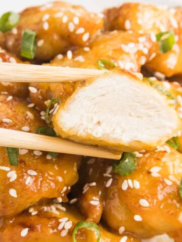 Close up of orange chicken bite.