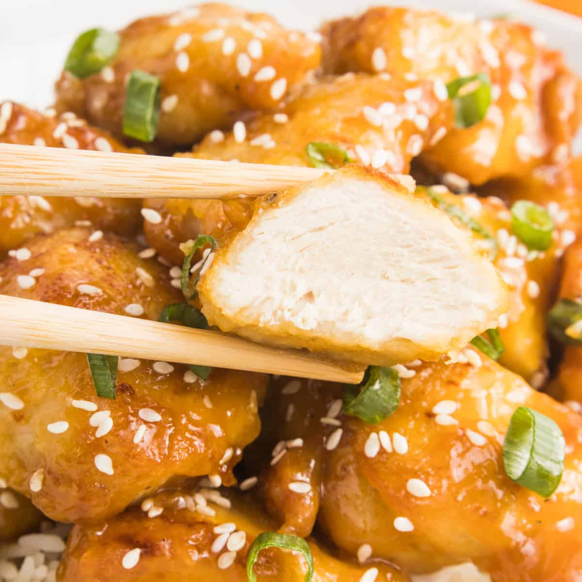 Close up of orange chicken bite.