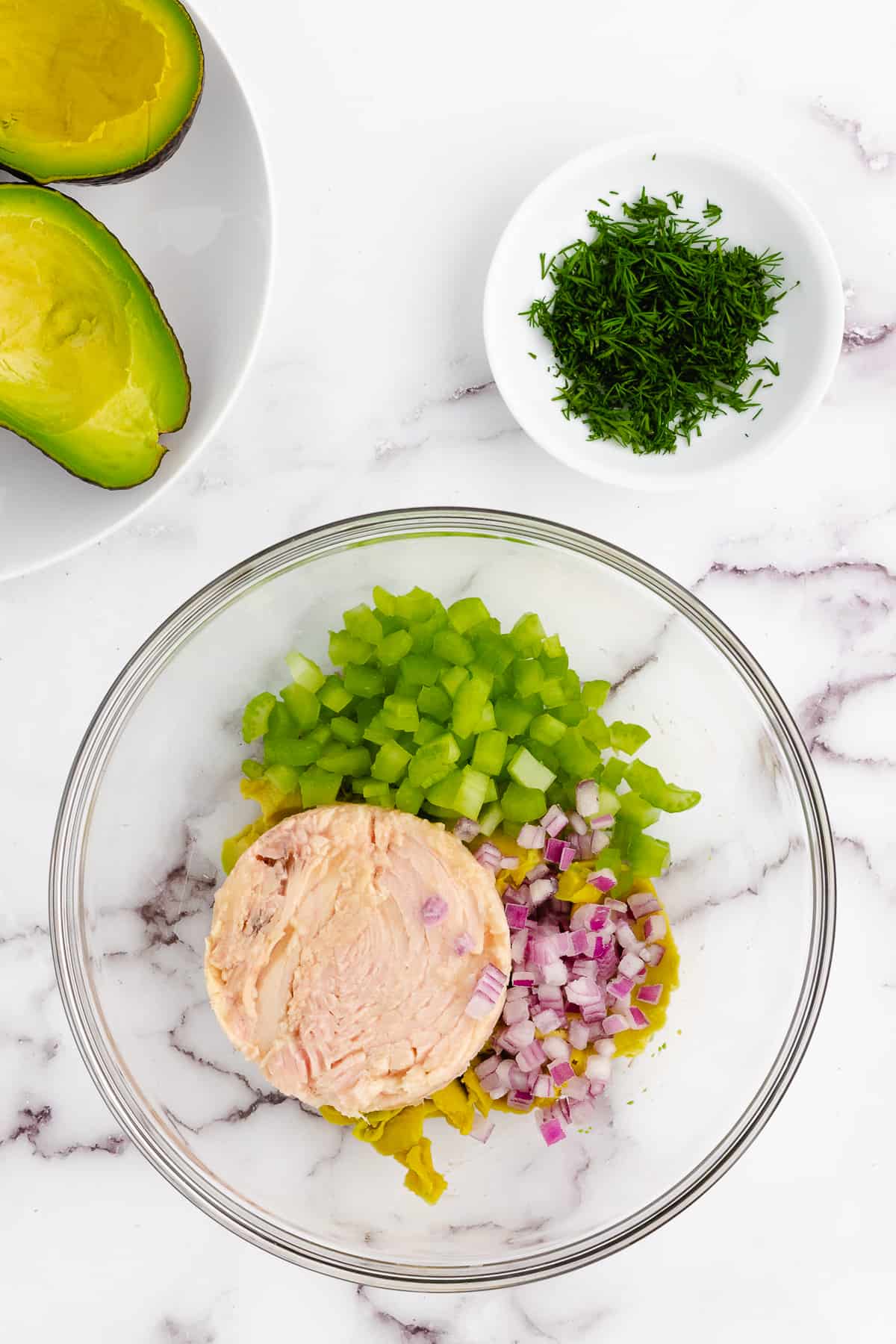 Tuna salad ingredients in a bowl.