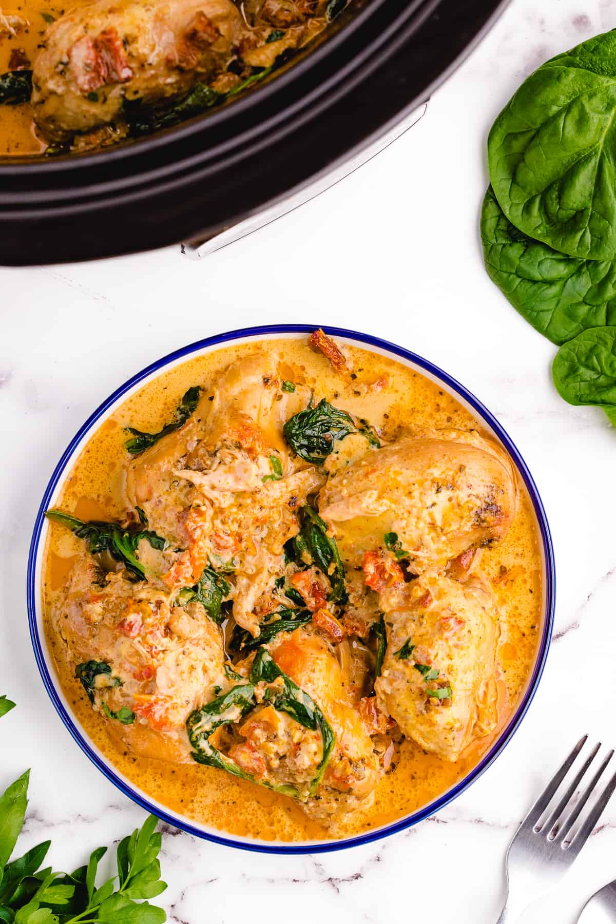 A plate of tuscan chicken being served.