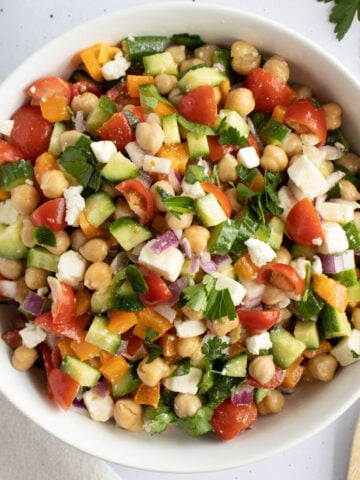 chickpea salad mixed together in a bowl.