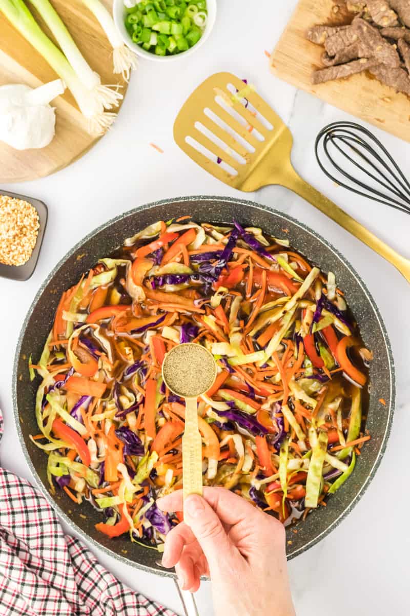 Seasoning the stir fry mixture.