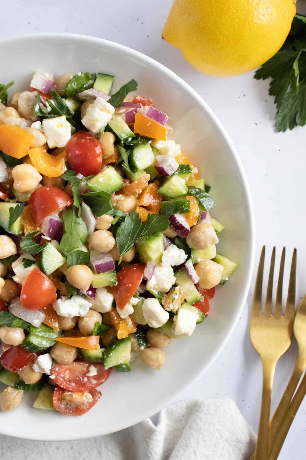 chickpea salad mixed together in a bowl.