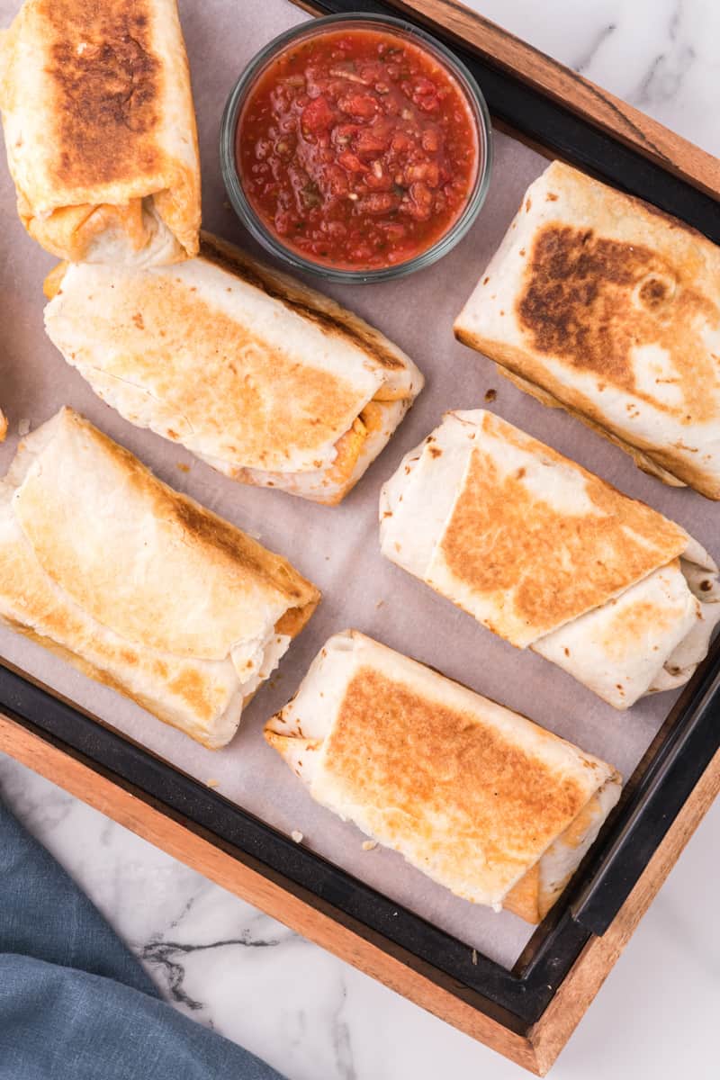 Freshly rolled and fried breakfast burritos.