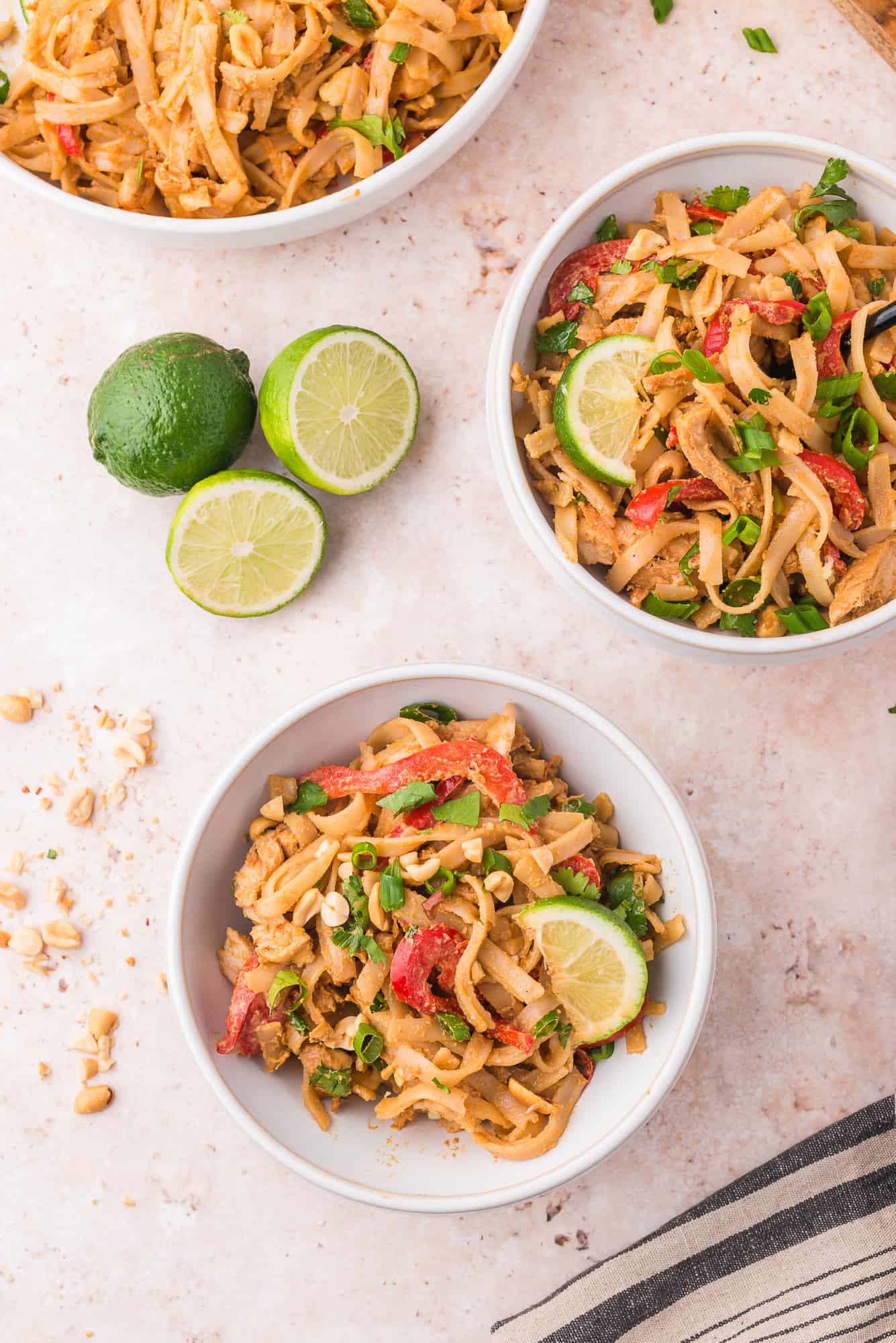 Prepared and served bowls of thai peanut noodles.