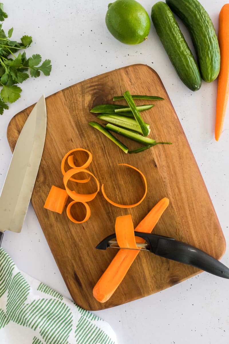 The process of slices carrots into ribbons.
