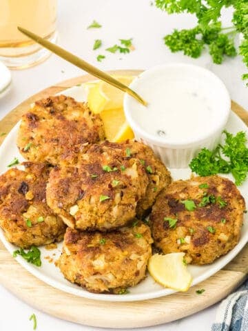 Fresh crab cakes being served on a plate.