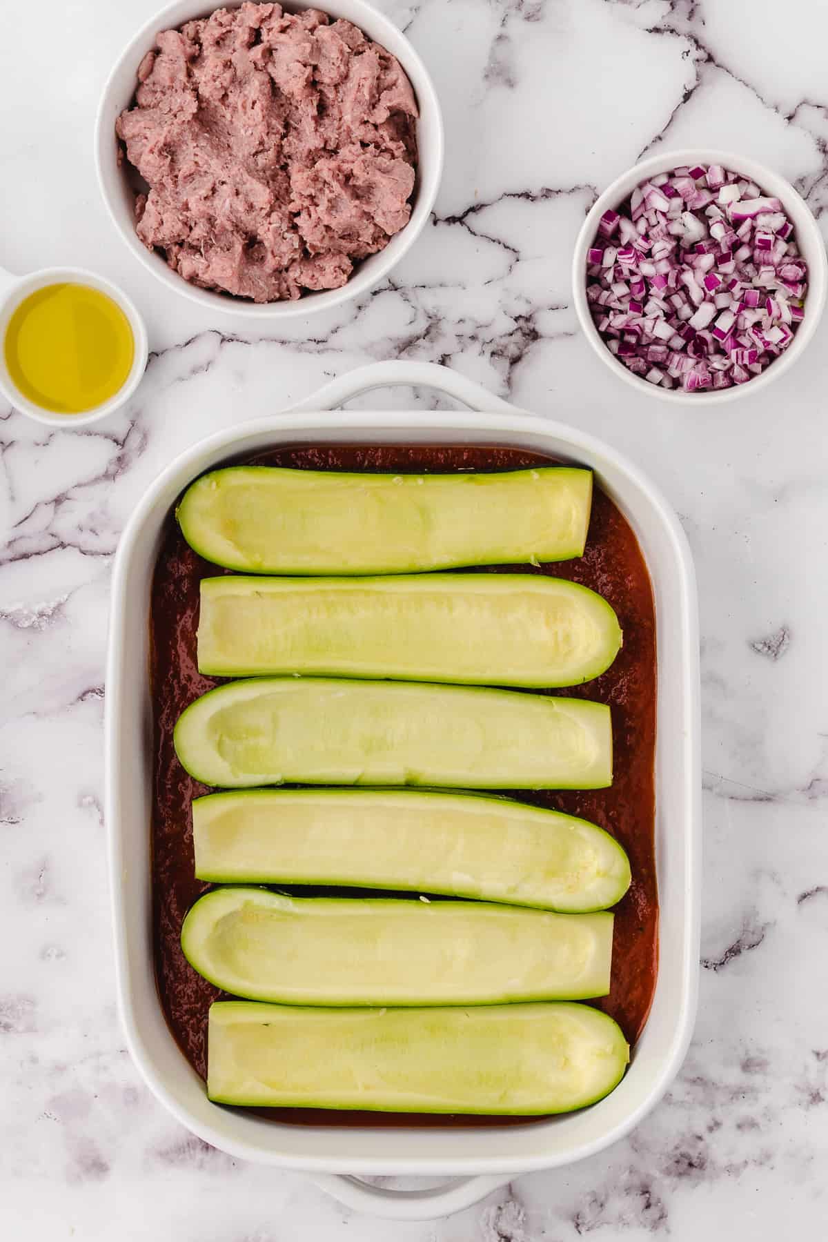 Italian CHicken Stuffed Zucchini -3 zucchini scooped out in dish