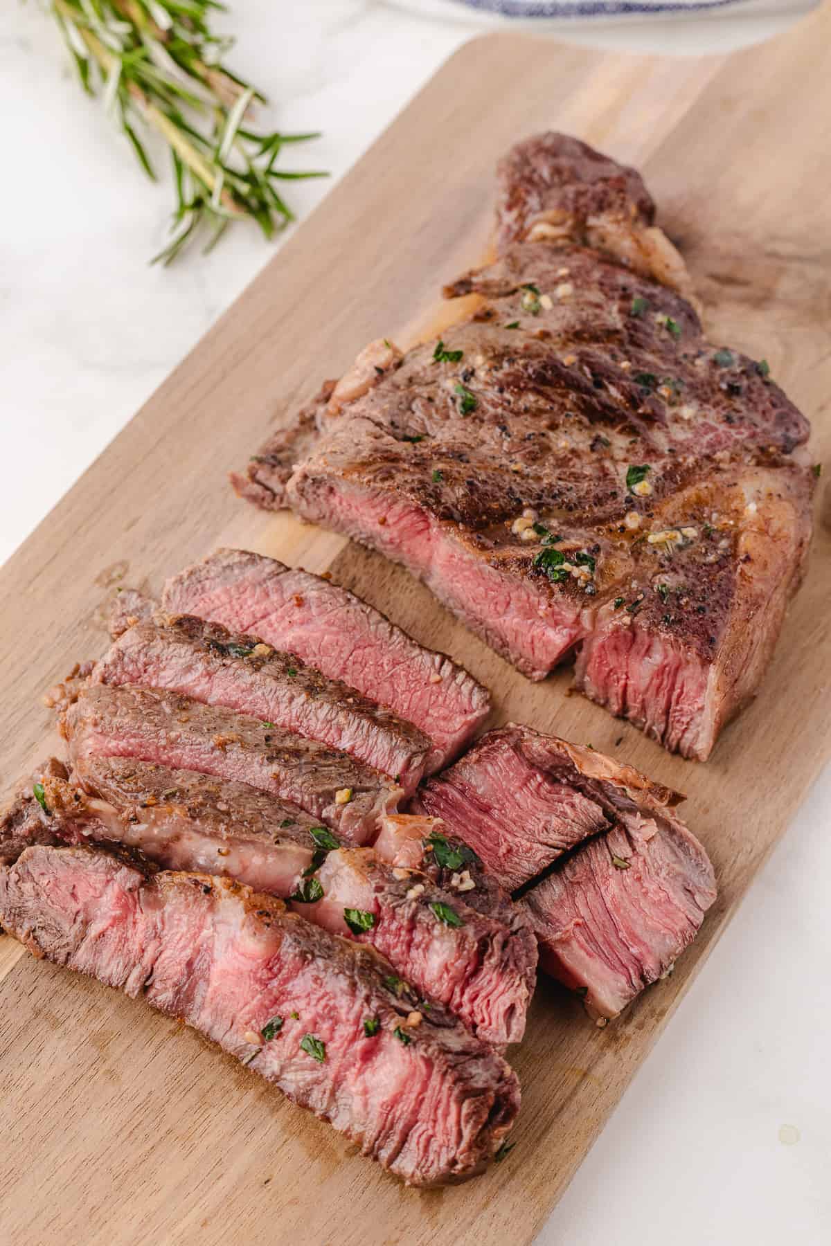 cast iron ribeye steak cutting on a cutting board