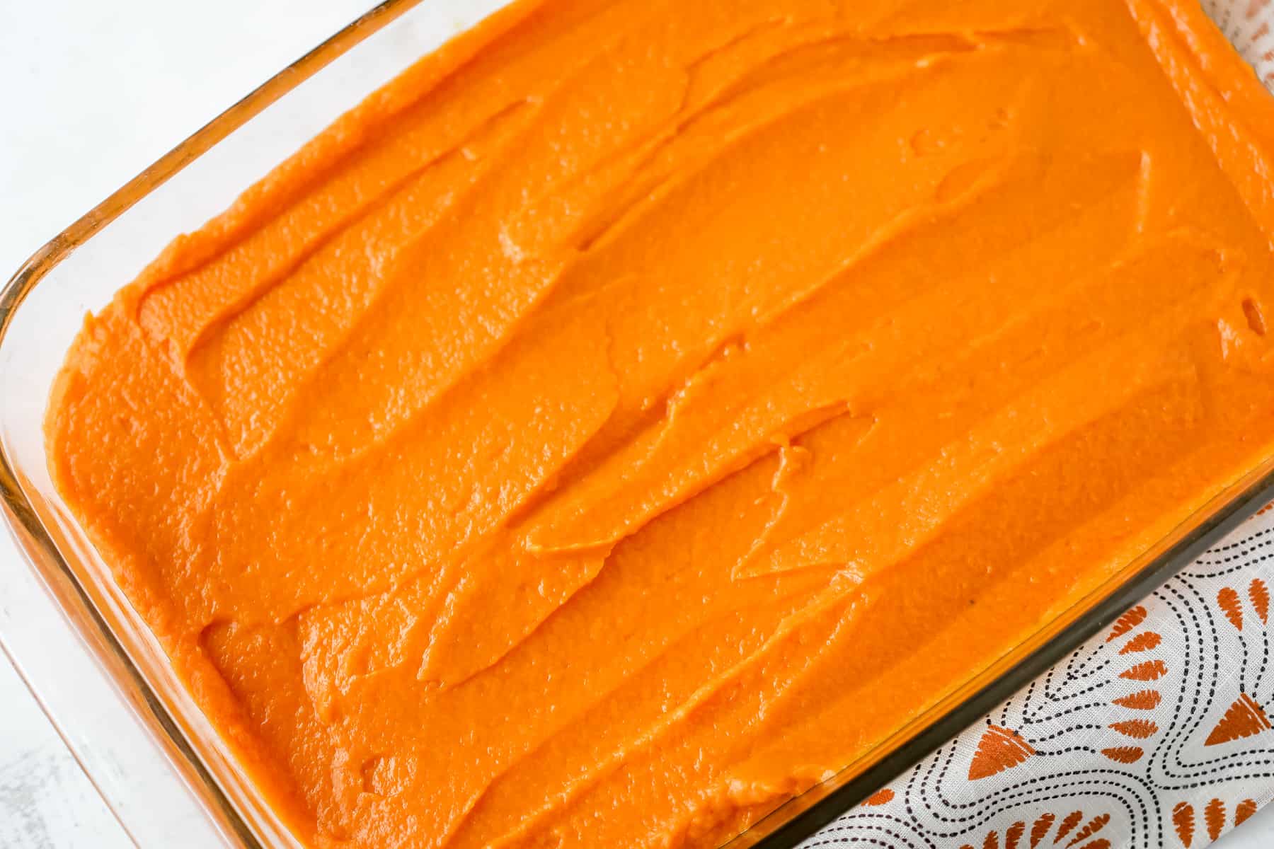 spread the cooked sweet potatoes in a baking dish