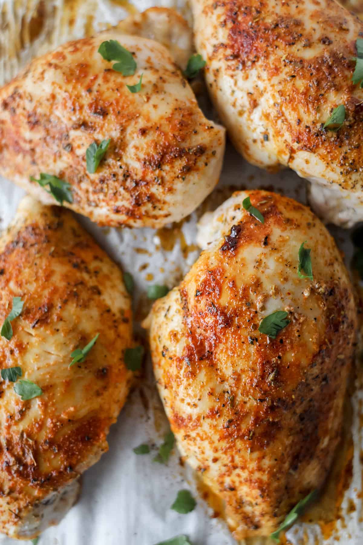 baked chicken breasts getting pulled out of the oven after roasting