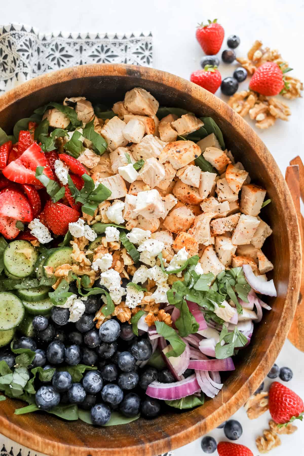 chicken strawberry salad in a wooden salad bowl
