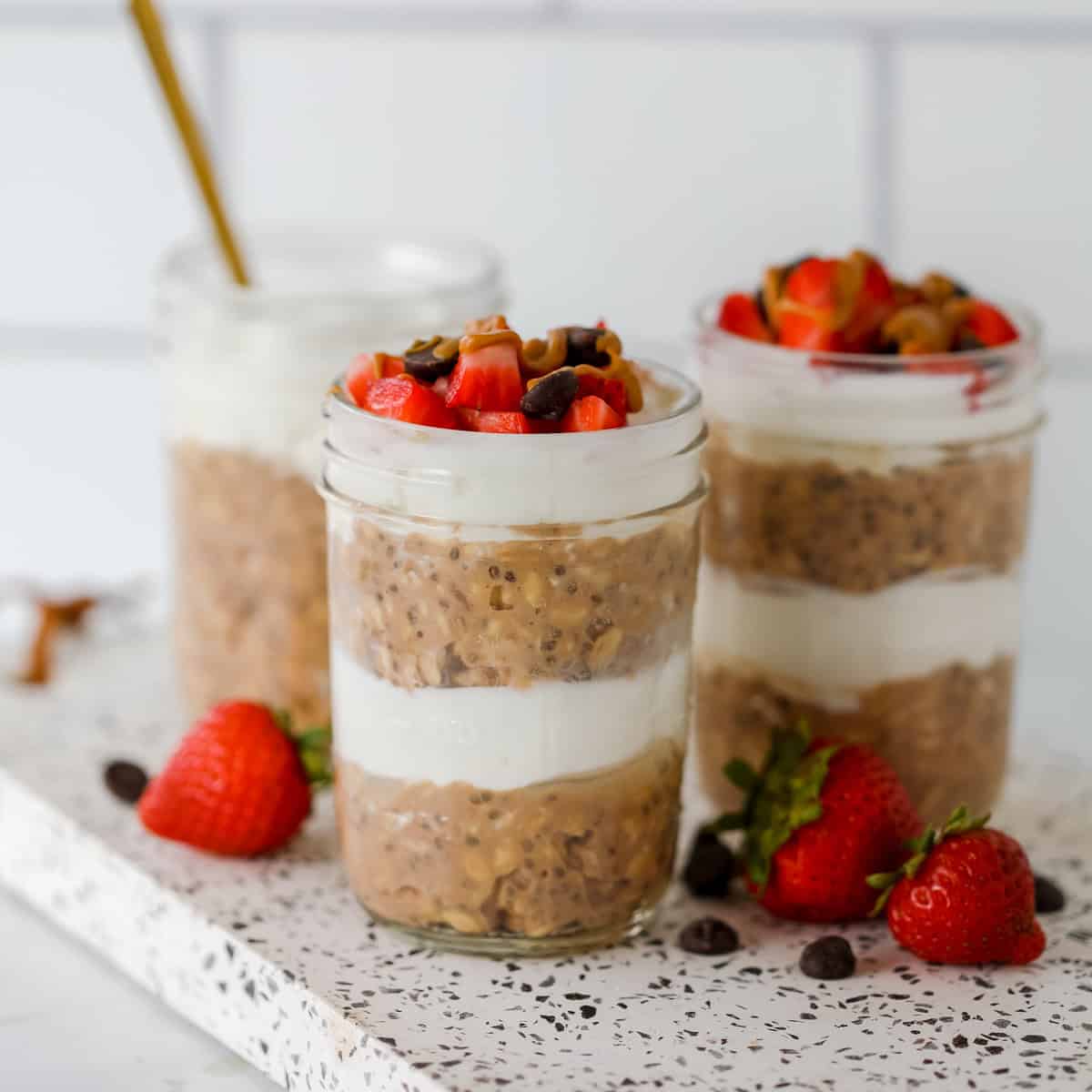 layered chocolate protein powder overnight oats in a jar with Greek yogurt to make parfaits.