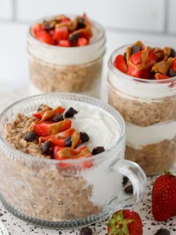 close up image of chocolate overnight oats in different sized storage jars