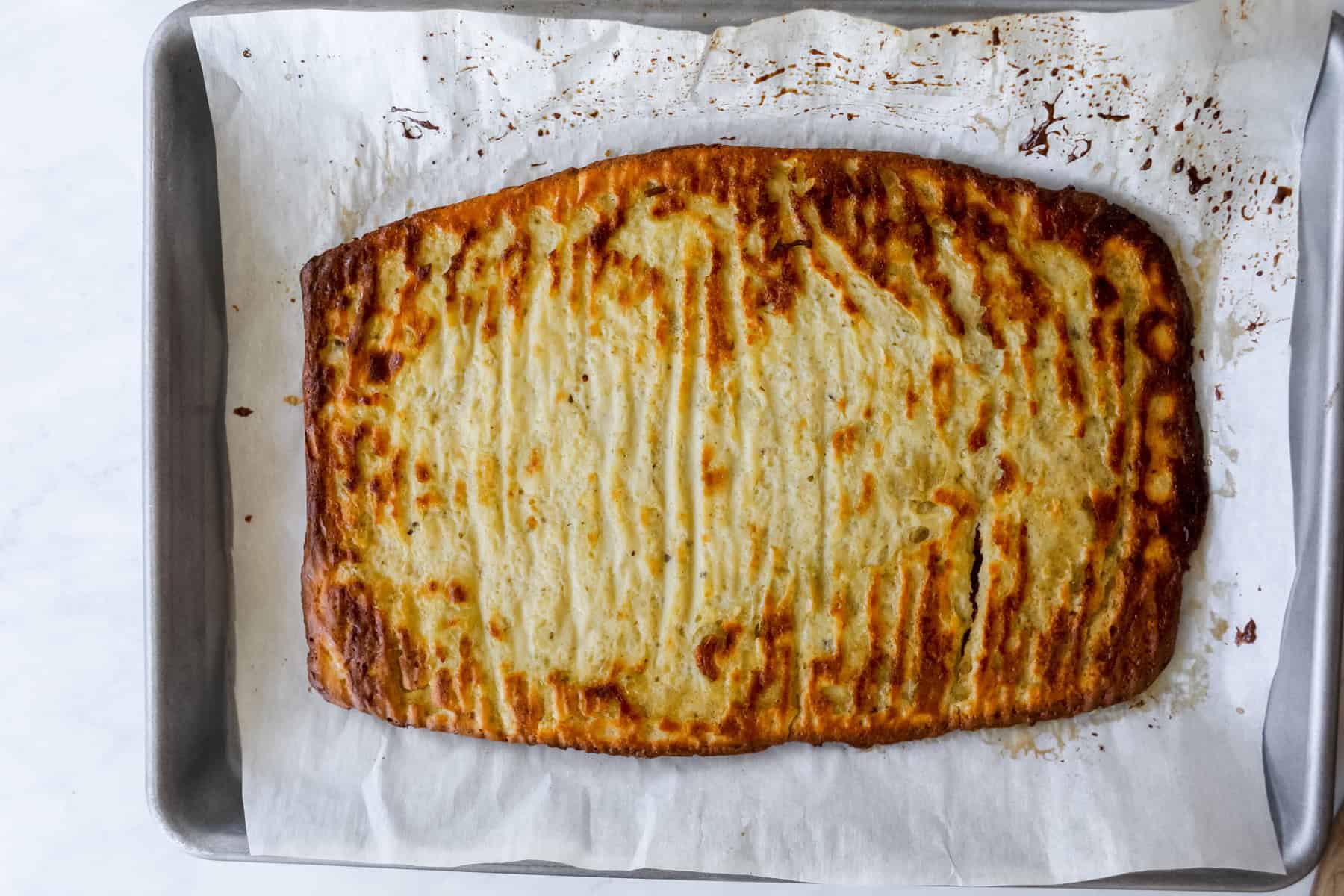 cooked cottage cheese flatbread laying on a pan cooling