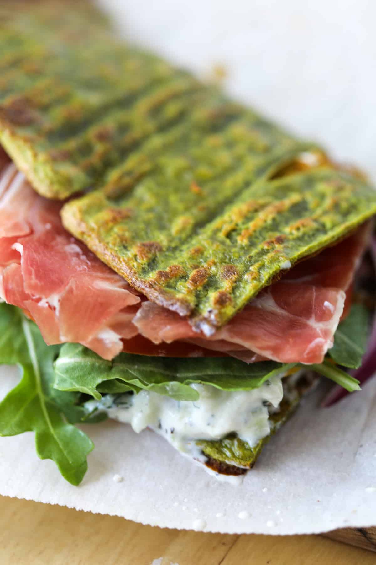 a cottage cheese flatbread wrap on a white plate with meat and vegetables