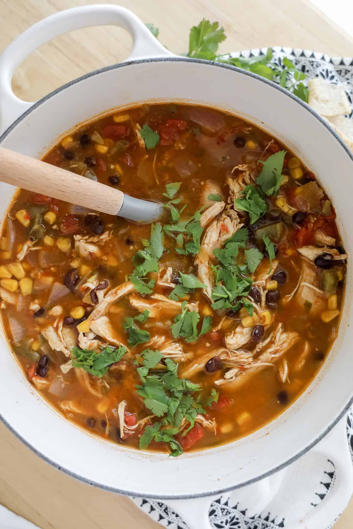 healthy chicken taco soup in a white soup pot sprinkled with cilantro
