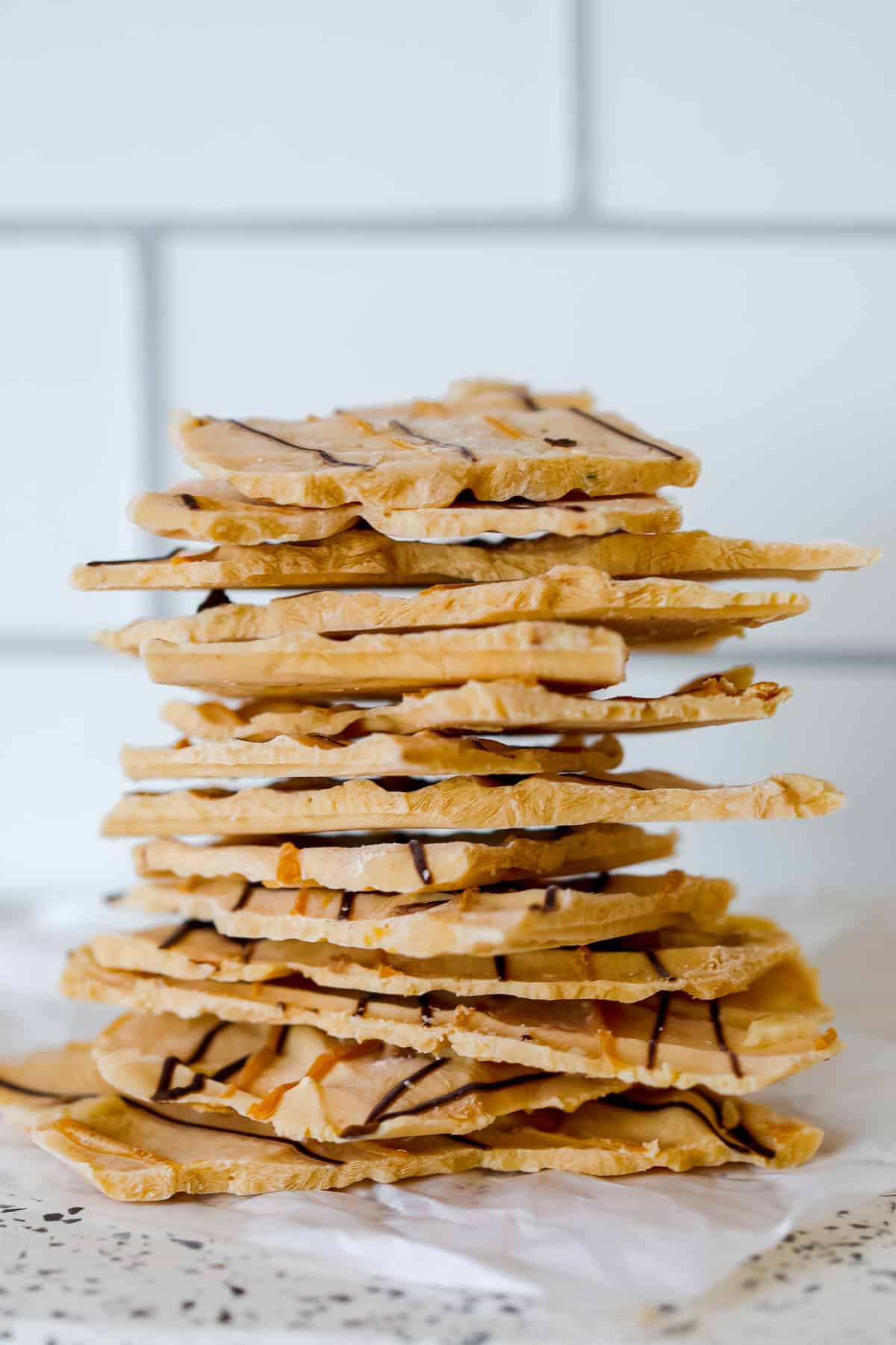 protein yogurt bark stacked up on a marble cutting board