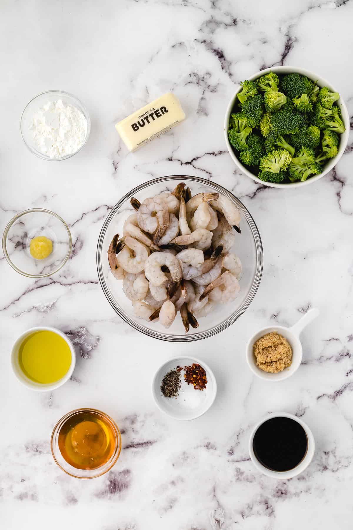 broccoli shrimp ingedients on a white marble background 