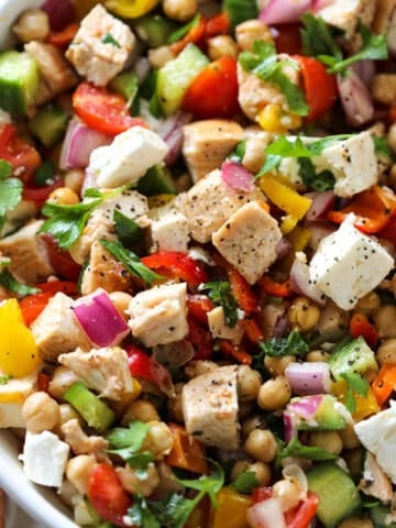 close up of the chicken salad with feta and chickpeas in a white bowl before serving