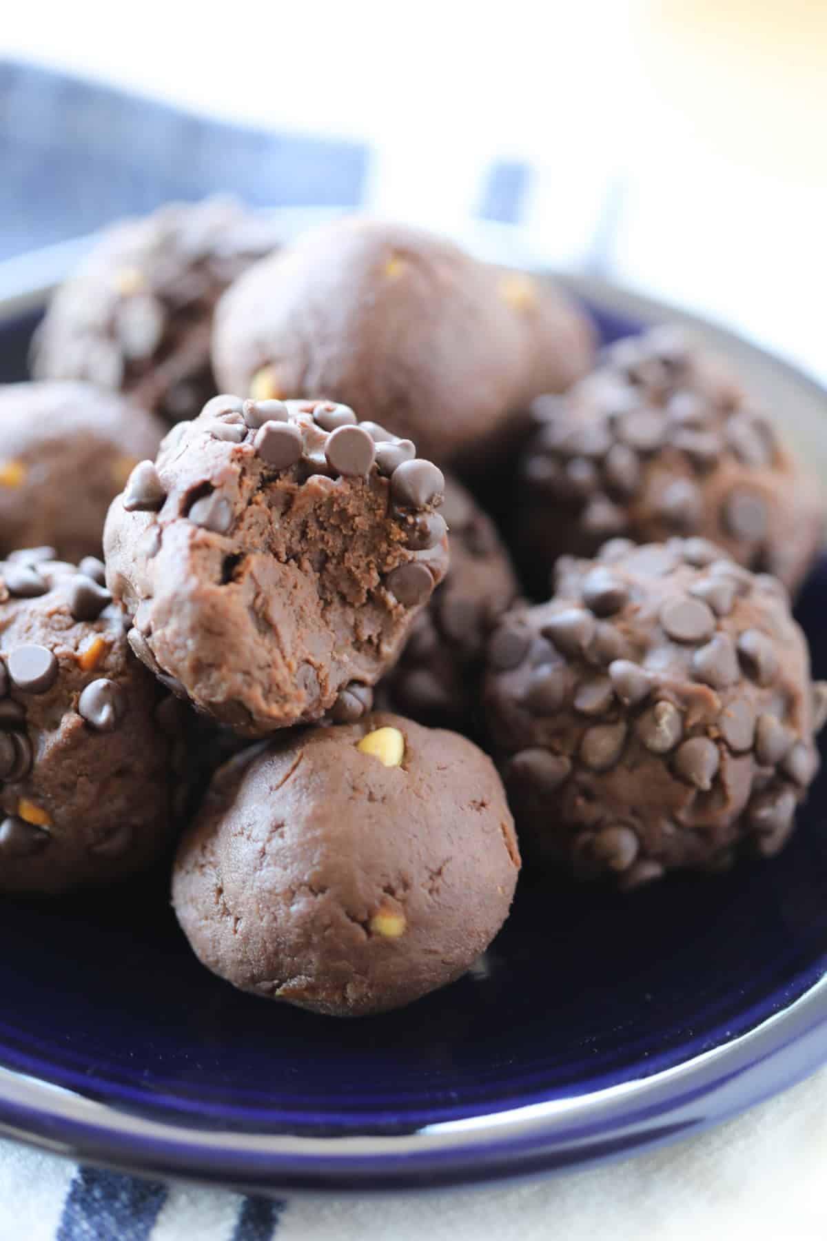 protein chocolate balls with a bite out of a ball rolled in chocolate chips