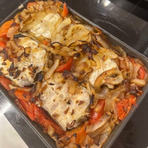freshly baked eel in a pan with vegetables