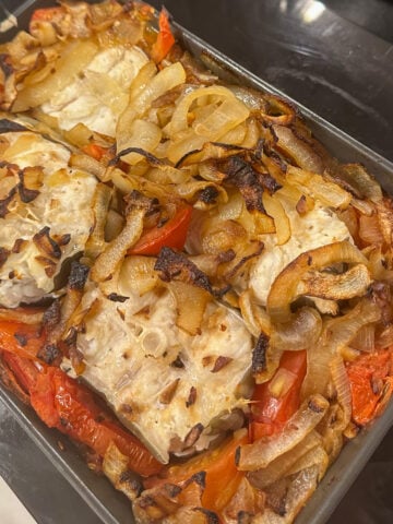 freshly baked eel in a pan with vegetables