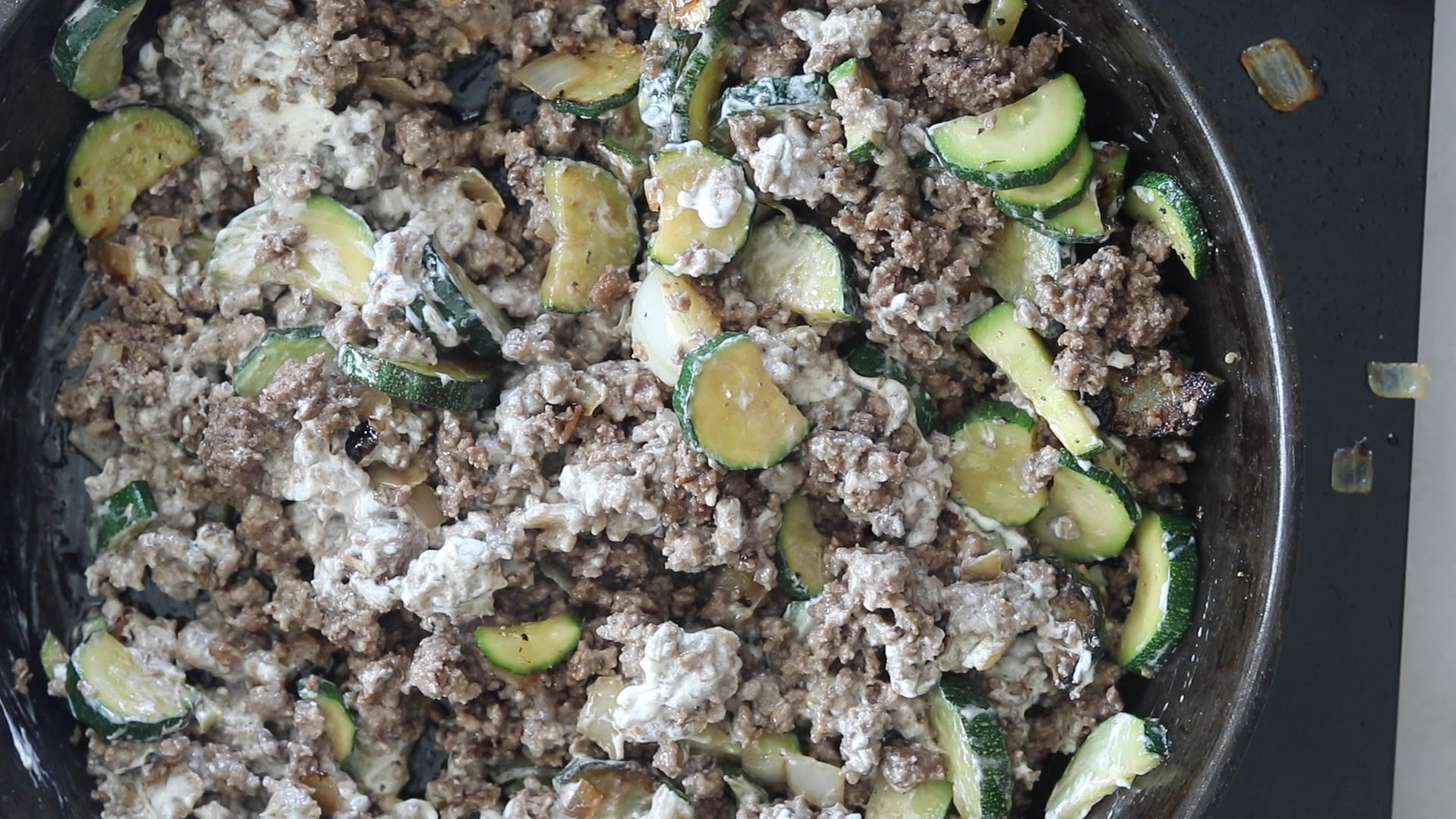 adding sour cream and cream cheese to the ground beef 