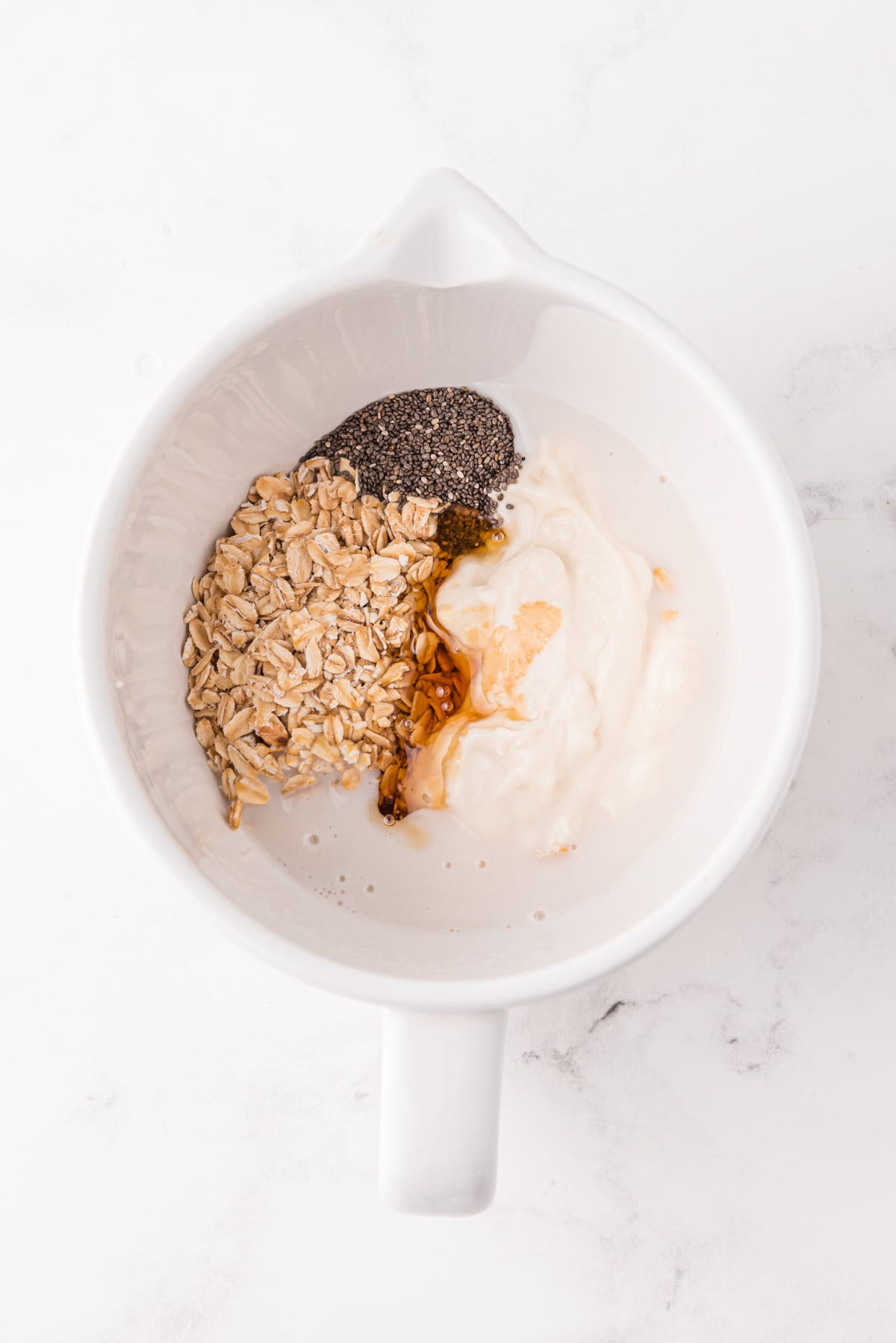 adding the banana chia seeds and peanut butter to the mixing bowl