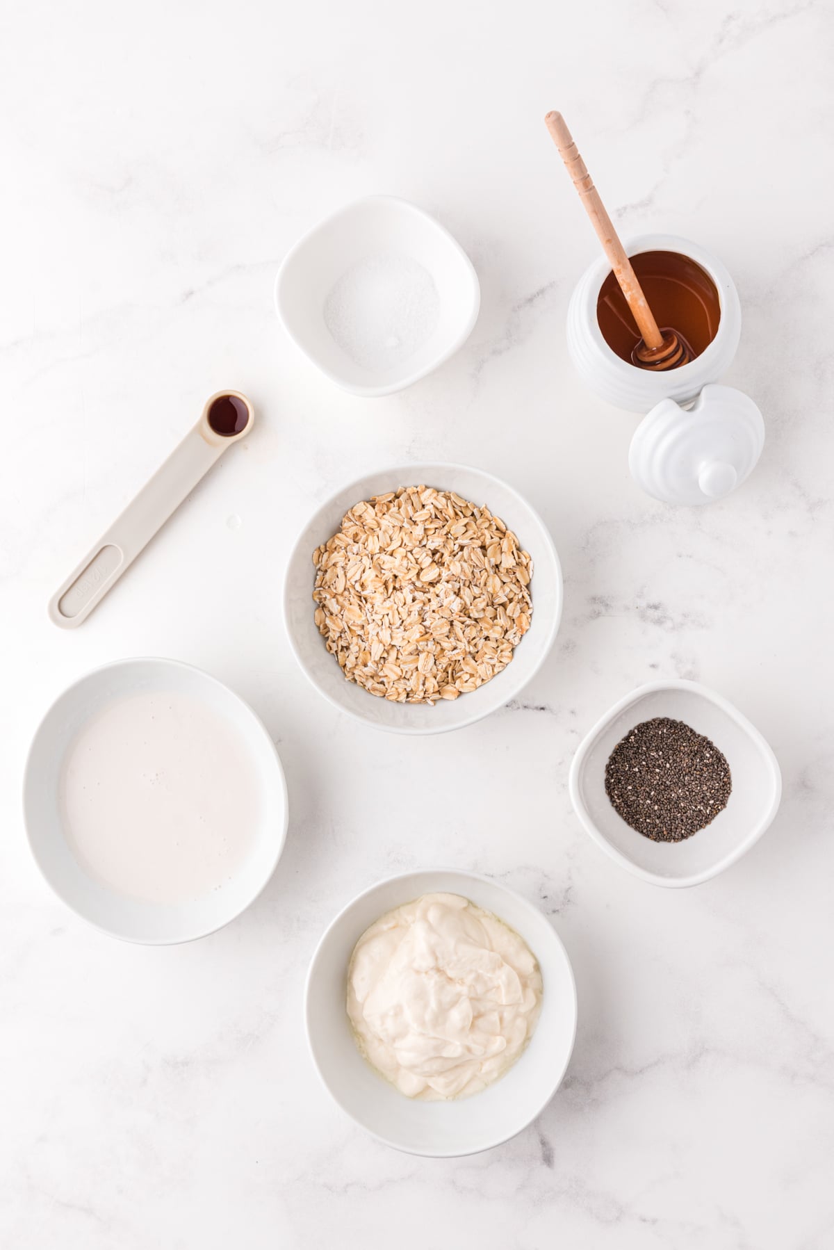 banana chia seed overnight oats ingredients on a white cutting board