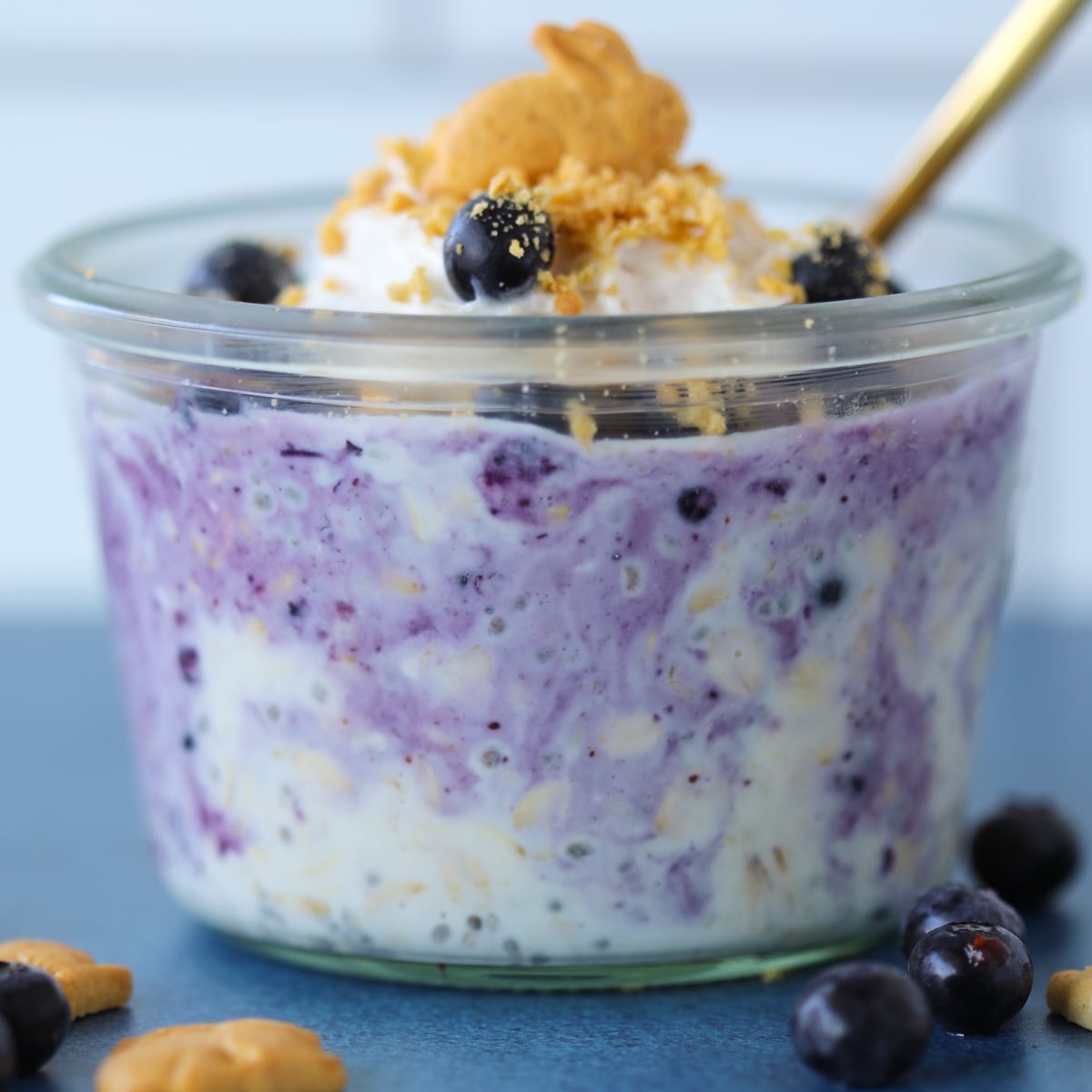 berry cheesecake overnight oats with frozen blueberries mixed in