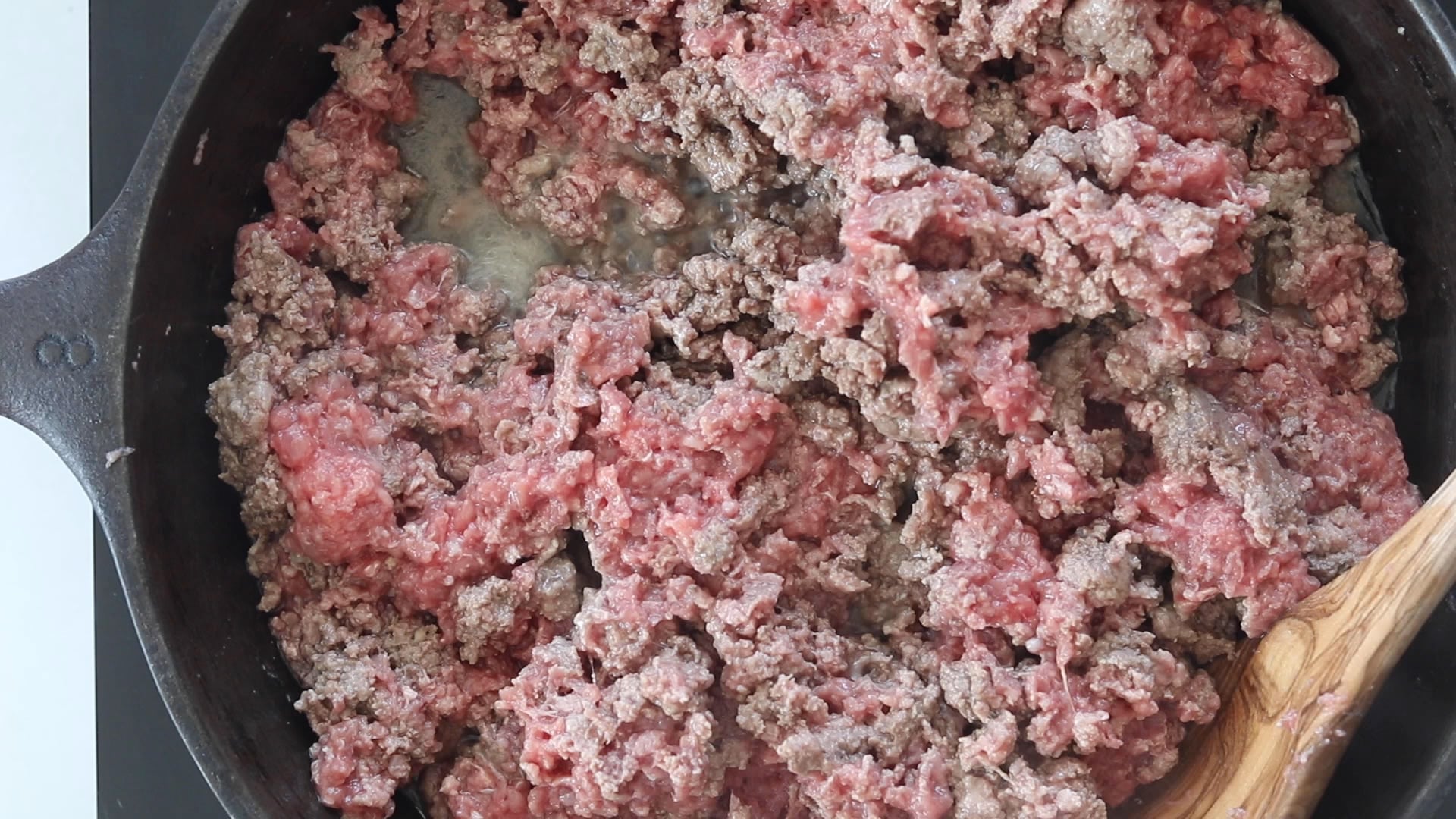 browning ground beef in a skillet for the zucchini ground beef casserole