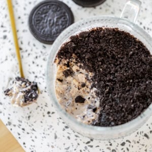 close up of cookies and creams overnight with a spoon of oats on the side